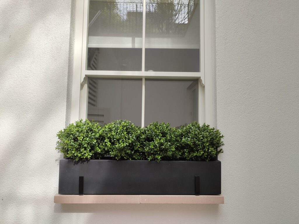 Artificial Buxus balls in polystone window box London Planters